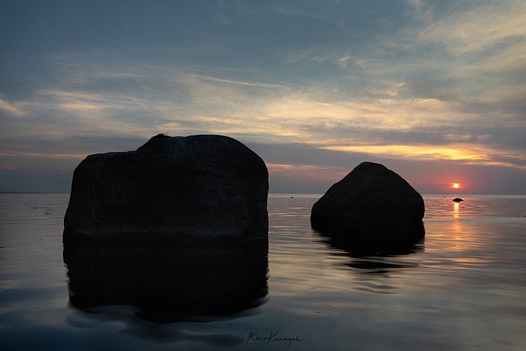 Sun setting behind erratic boulders